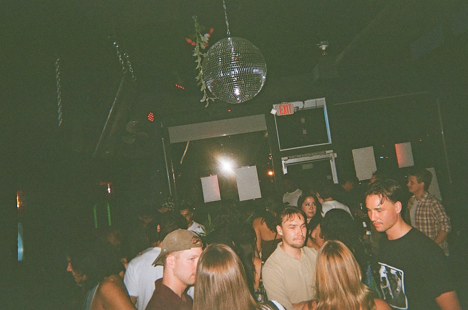 A packed room under the disco ball at Central Records