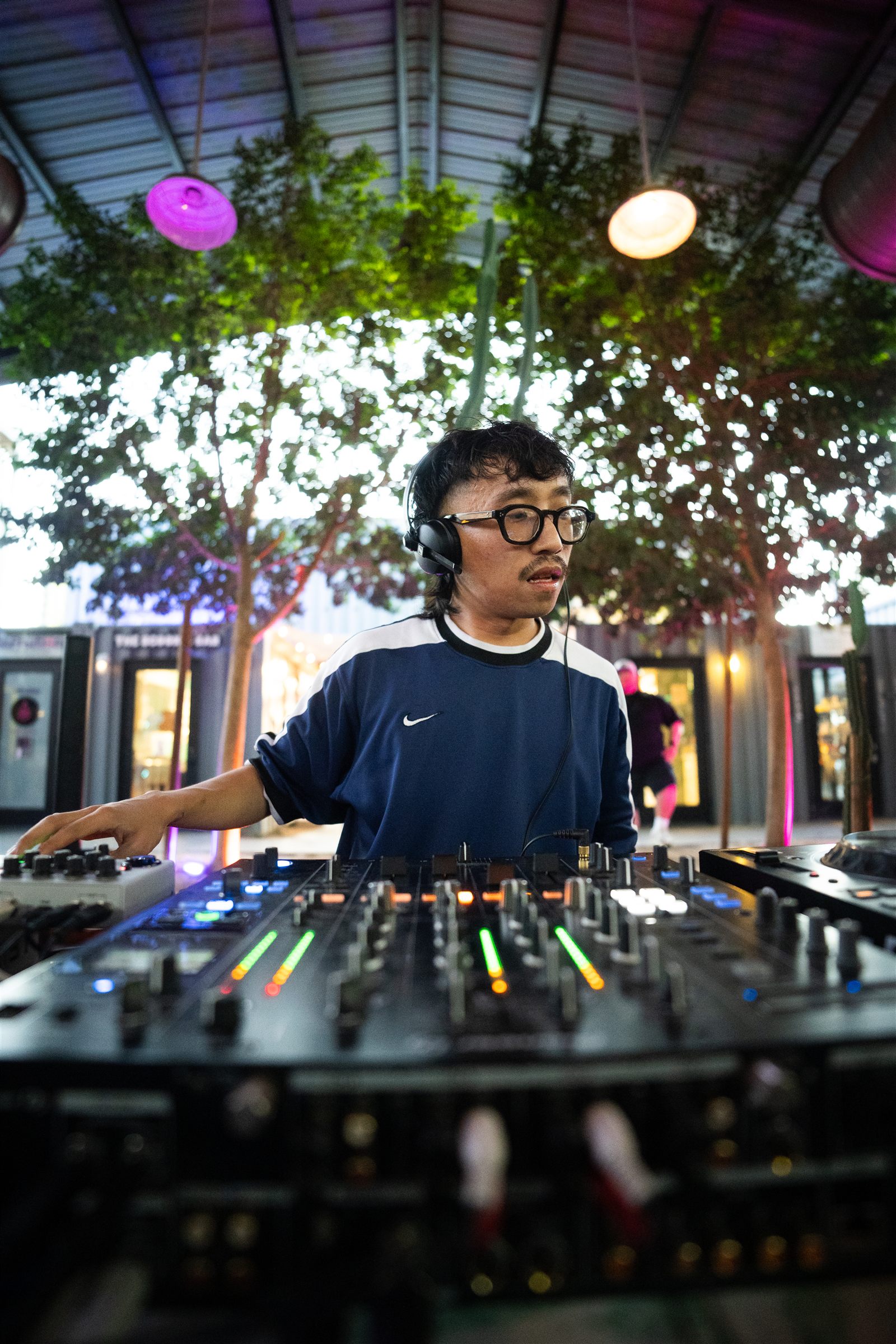 A DJ behind the decks at an open-air ATRIUM night